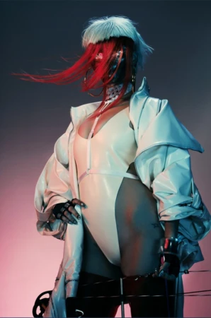 Stylish woman with futuristic mask, white jacket, and red hair, posing in a studio with blue and red background lighting.