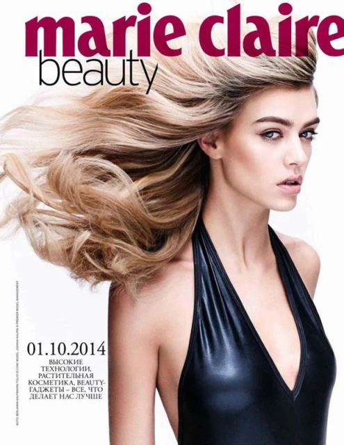 Marie Claire beauty magazine cover featuring a blonde model in a black halter top against a white background, with bold text overlay.