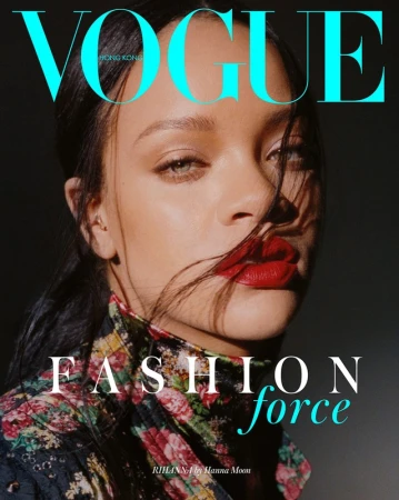 Close-up portrait of Rihanna with dark hair, vibrant red lipstick, and a floral print turtleneck styled by Anya Ziourova.
