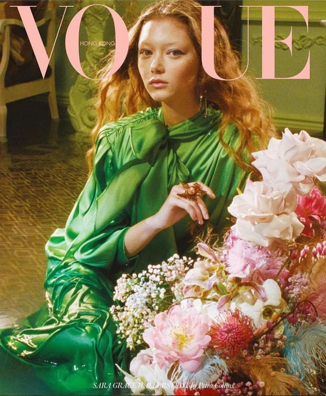 Vogue Hong Kong cover featuring a red-haired woman in a green satin dress posing with an elaborate bouquet of flowers.