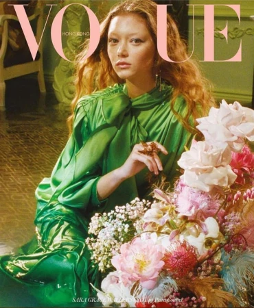 Vogue Hong Kong cover featuring a red-haired woman in a green satin dress posing with an elaborate bouquet of flowers.
