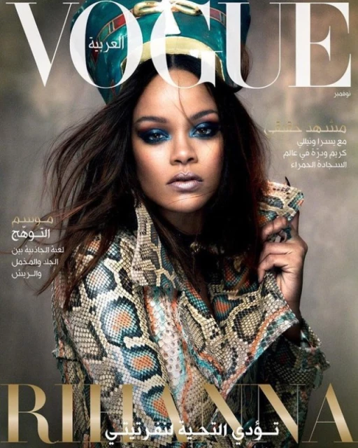 Vogue Arabia magazine cover featuring Rihanna wearing a snakeskin jacket and turquoise headpiece, with heavy blue makeup and dramatic pose.