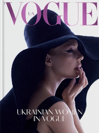 Profile portrait of a woman wearing a wide-brim black hat and black dress against a white background
