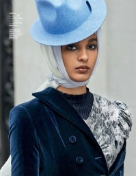 Model wearing a blue fedora, white headscarf, and velvet blazer styled by Anya Ziourova in Los Angeles