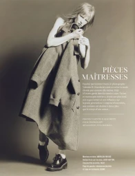 Model in grey wool coat and black leather shoes styled by Anya Ziourova against a neutral background.