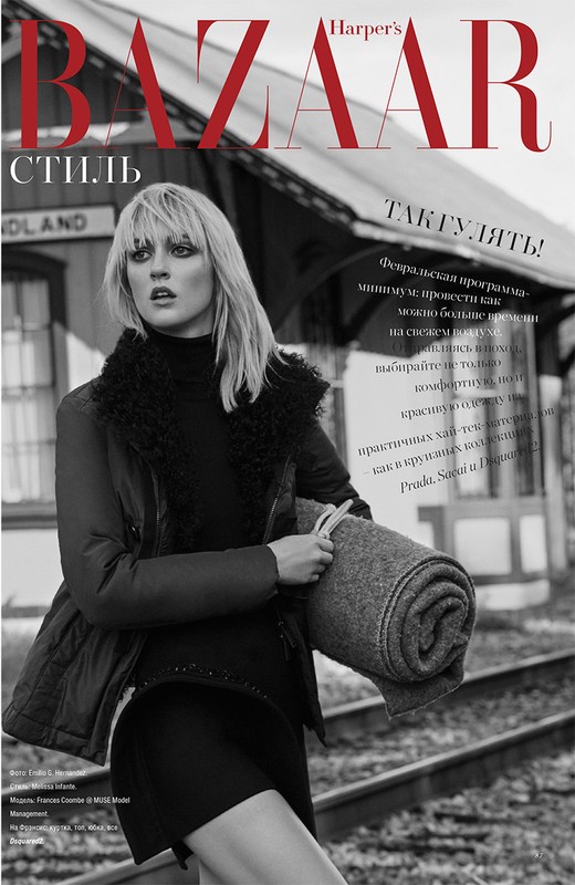 Black and white fashion editorial featuring a fair-skinned woman with blonde hair in a dark outfit holding a blanket, outdoors.