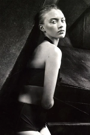 Monochrome portrait of a woman looking back over her shoulder wearing dark swimwear with make-up by April Greaves in Los Angeles.