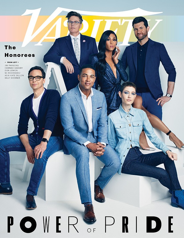 Group portrait of Variety 'Power of Pride' honorees posing on a set of white stairs, against a light backdrop in a photo studio.
