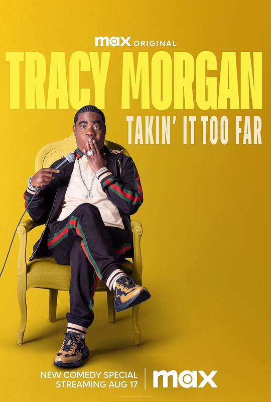 Tracy Morgan sits in a yellow chair holding a microphone, smiling in a promotional shot for his comedy special with a yellow background.