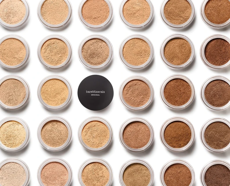 Assortment of BareMinerals Original foundation in various shades arranged on a clean white background, showcasing a diverse range of skin tones.