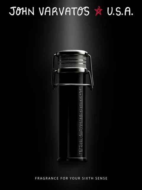 John Varvatos fragrance in a sleek black bottle with a silver cap, presented against a dark backdrop and highlighted by a spotlight.