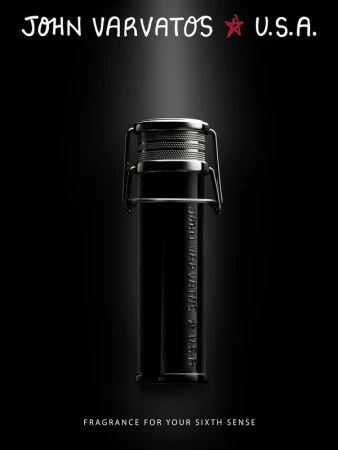 John Varvatos fragrance in a sleek black bottle with a silver cap, presented against a dark backdrop and highlighted by a spotlight.