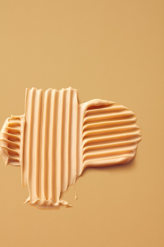 Beige cosmetic cream swatch with combed ridges on a matching beige background styled by Beverley Hyde