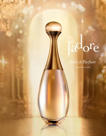 A luxury gold perfume bottle centered in front of a glowing archway with soft warm lighting.