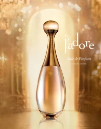 A luxury gold perfume bottle centered in front of a glowing archway with soft warm lighting.