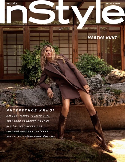 InStyle cover featuring Martha Hunt wearing a brown coat, leaning against a rock formation with a building and foliage in background.