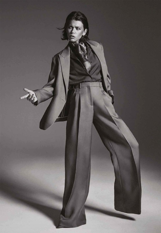 Black and white editorial portrait of a woman in an oversized suit and silk scarf styled by Bobette Cohn