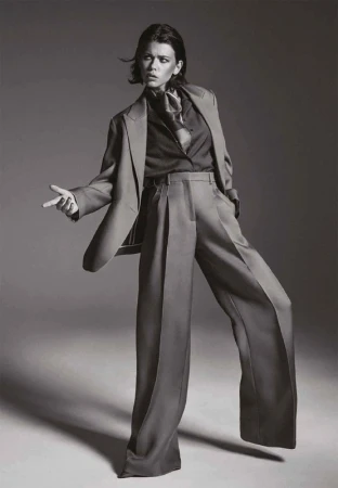 Black and white editorial portrait of a woman in an oversized suit and silk scarf styled by Bobette Cohn