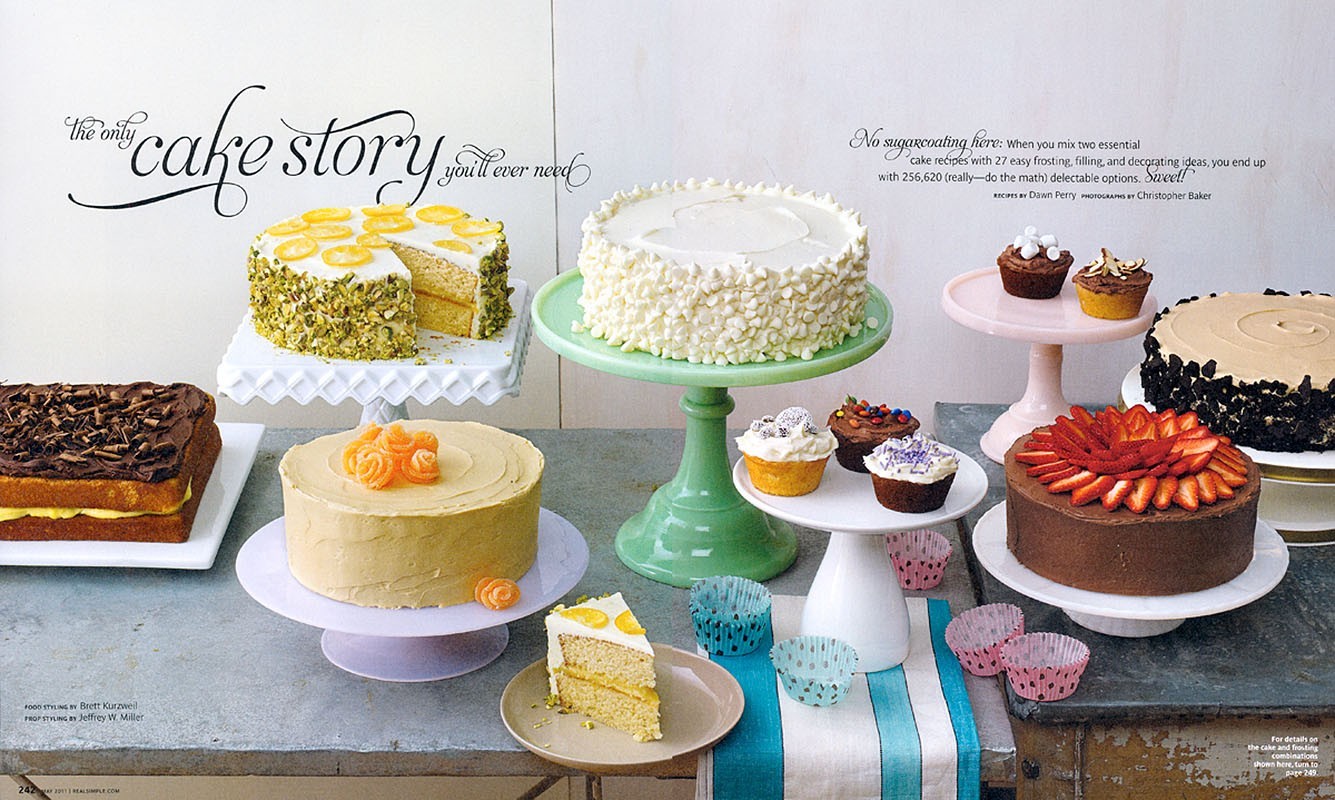 Eye-level shot of various cakes and cupcakes decorated and displayed on cake stands, featuring different flavors and toppings against a white background.