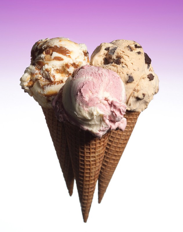 Three ice cream cones with different flavors - caramel nut, chocolate chip, and strawberry - against a purple gradient background.