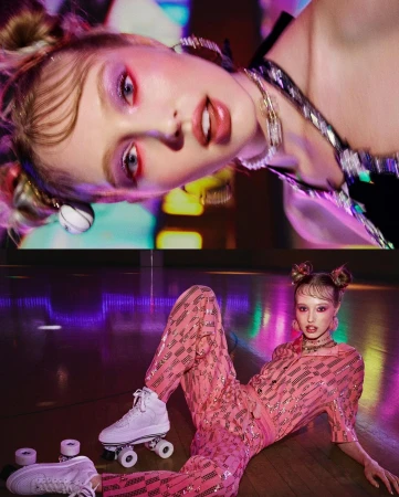 Young woman in pink sequin suit poses with retro roller skates indoors. Bright makeup and unique hairstyle for fashion editorial.