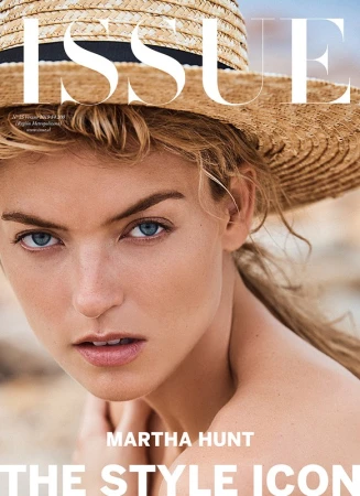 Magazine cover featuring a fair-skinned adult female model with blonde hair wearing a straw hat, posing in a close-up shot.