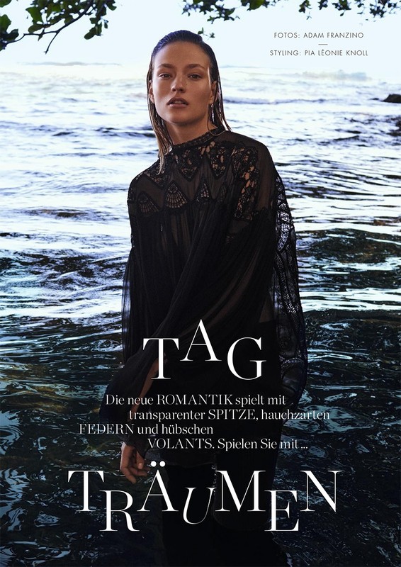 Model with wet hair wearing a black lace blouse standing by water with text overlay