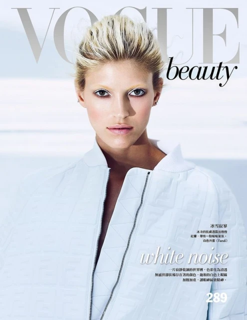 Vogue beauty cover featuring a fair-skinned woman with blonde hair and light jacket posing against a bright white background.