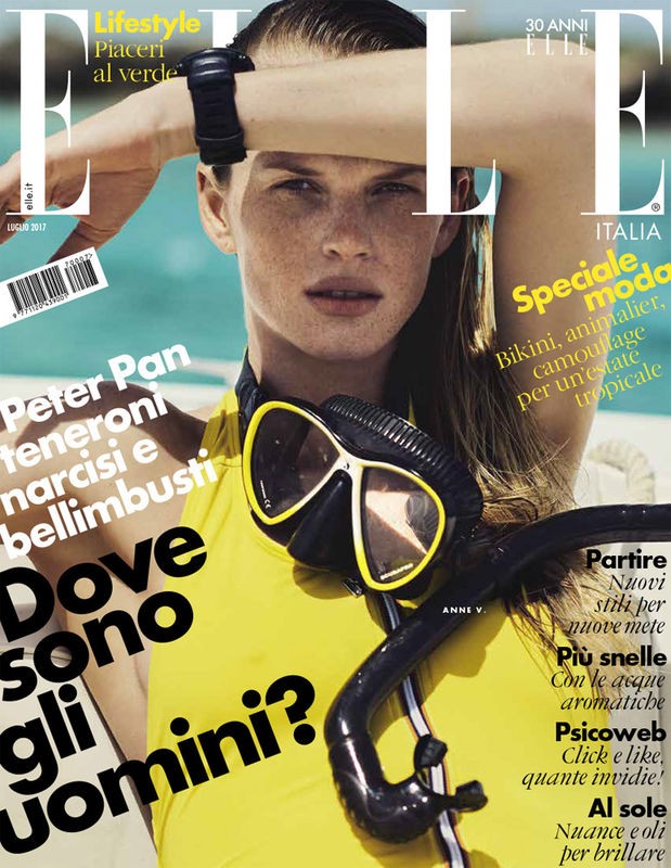 Elle Italia magazine cover featuring a fair-skinned woman wearing a yellow top, diving mask, and wristwear, with the magazine's logo.