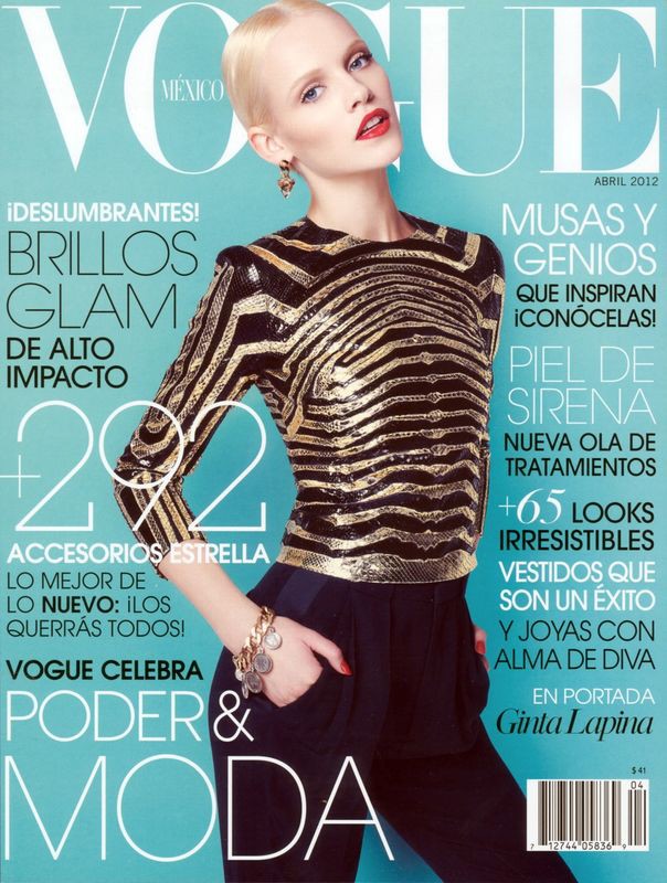 Vogue Mexico cover featuring a blonde woman with red lipstick wearing a gold and black top, bracelet, and dark pants against a blue background.