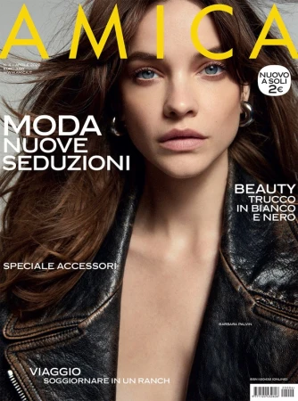 Close-up magazine cover portrait of model Barbara Palvin wearing a distressed black leather jacket with silver hoop earrings