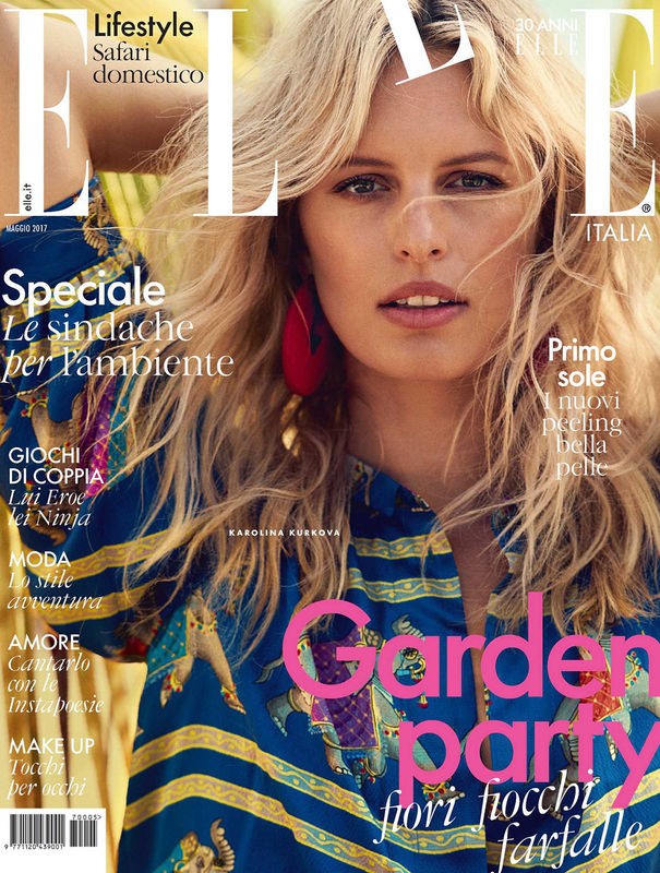Elle Italia magazine cover featuring a blonde woman in a patterned blouse, set against an out-of-focus green background, with bright pink text.