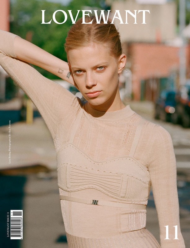 Magazine cover featuring a fair-skinned woman with red hair wearing a knit top and skirt, posing outdoors on a city street with LOVEWANT masthead.