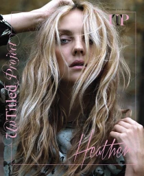 Portrait of a blonde woman with wavy hair touching her head against an out-of-focus background with makeup by Charlotte Day
