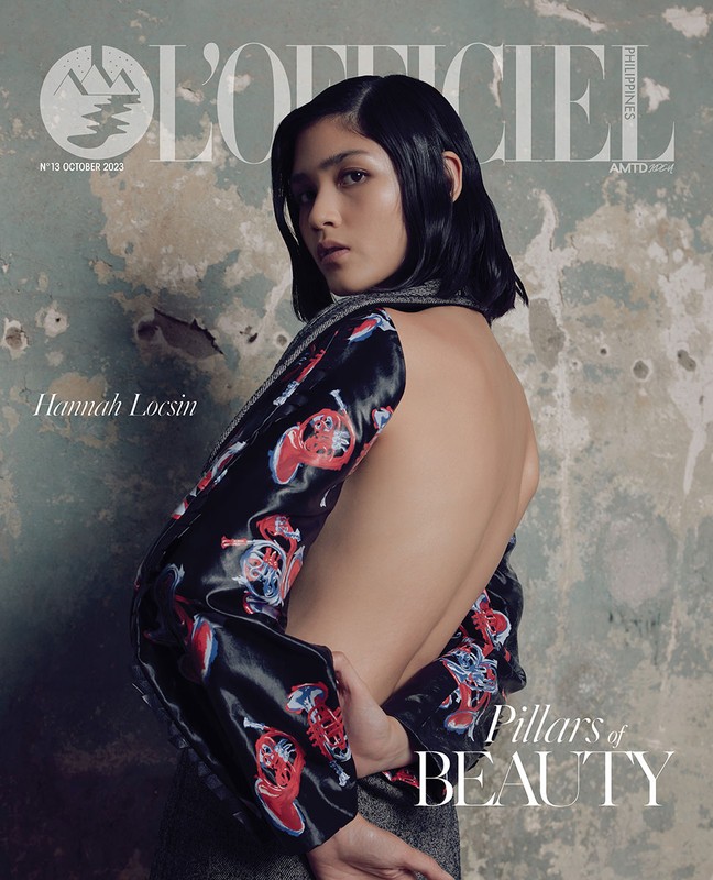 L'Officiel Philippines magazine cover featuring Hannah Locsin, posing with bare back and patterned sleeves against a mottled wall backdrop.