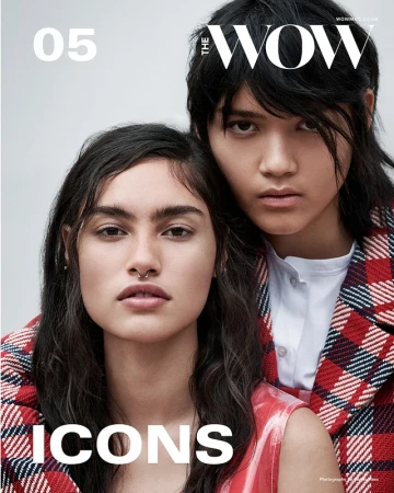 Fashion magazine cover featuring two adult women in a photo studio. One woman has a nose ring, and both wear red and white plaid jackets.