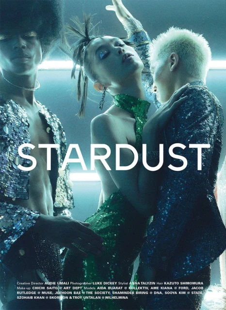 Fashion editorial shot featuring three models with sparkly makeup and outfits. Two models flank one in the middle, studio lighting, and creative direction.