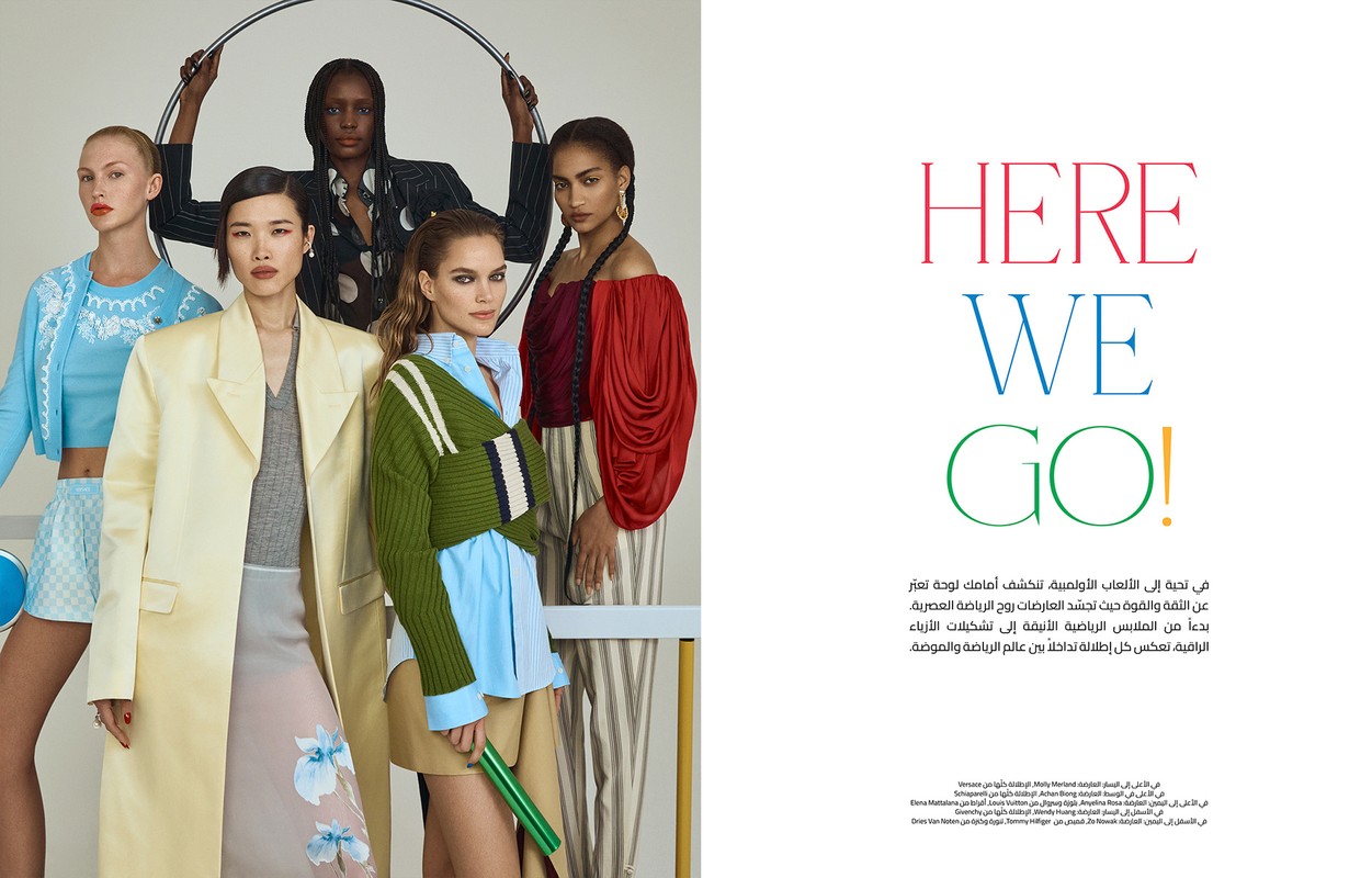 A group of five fashion models pose indoors against a white backdrop, showcasing apparel with vibrant colors, textures, and patterns.