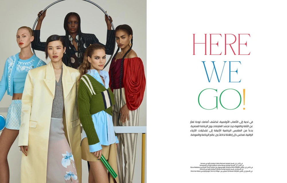 A group of five fashion models pose indoors against a white backdrop, showcasing apparel with vibrant colors, textures, and patterns.
