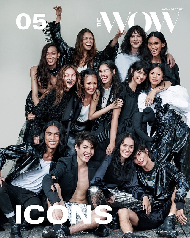 Magazine cover featuring a diverse group of fourteen young adults in a variety of stylish black outfits, all smiling. "The WOW" title is visible.