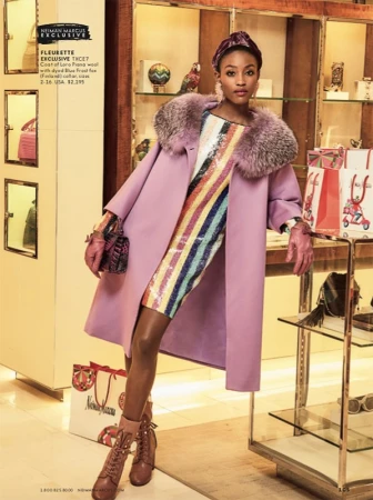 Elegant woman in a lilac coat and colorful sequin dress holds a purse. She wears heeled shoes, gloves, and a hair accessory indoors.