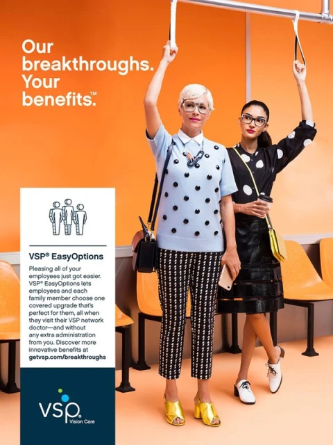 Two women on a bus are featured in a VSP ad, promoting vision benefits. One is fair-skinned with glasses, the other has darker skin and retro glasses.