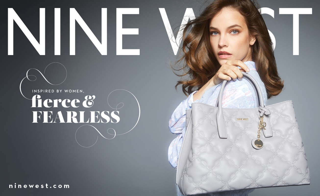 Fashion ad for Nine West handbag features a female model in a studio, holding a light grey quilted leather tote with gold accents.