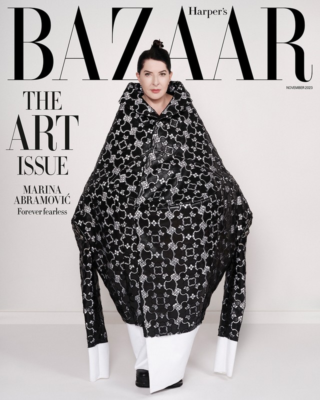 Fashion magazine cover featuring Marina Abramović wearing a patterned black cape with a high collar against a plain, light background.