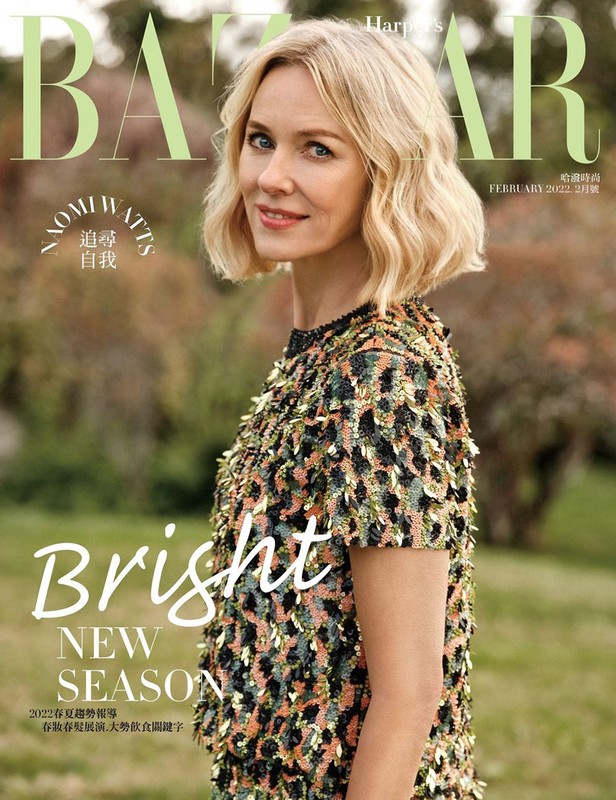 Naomi Watts on the cover of Harper's Bazaar, February 2022. She is fair-skinned with blonde wavy hair and a multi-colored embellished dress.