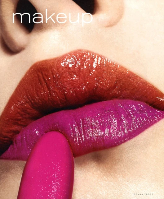 Close-up of a woman's face with vivid red and fuchsia lipstick applied on her lips. A lipstick tube is used to apply the makeup.
