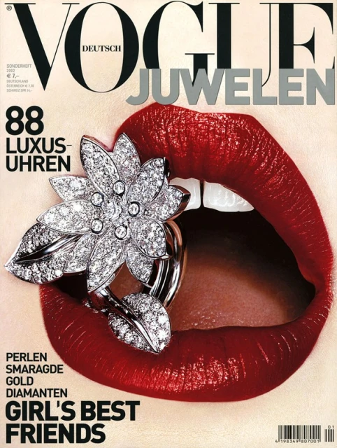 Vogue Deutsch magazine cover featuring a close-up of a woman's red lips with a diamond flower ring inside of the mouth, jewelry focused.