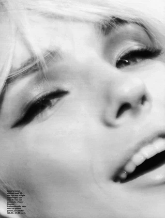 Close-up black and white portrait of a woman with dramatic winged eyeliner and blonde hair