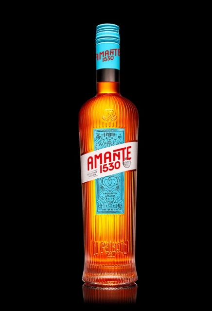 Eye-level studio shot of a bottle of Amante 1530 aperitivo. The bottle has a decorative aqua label and top against a solid black background.