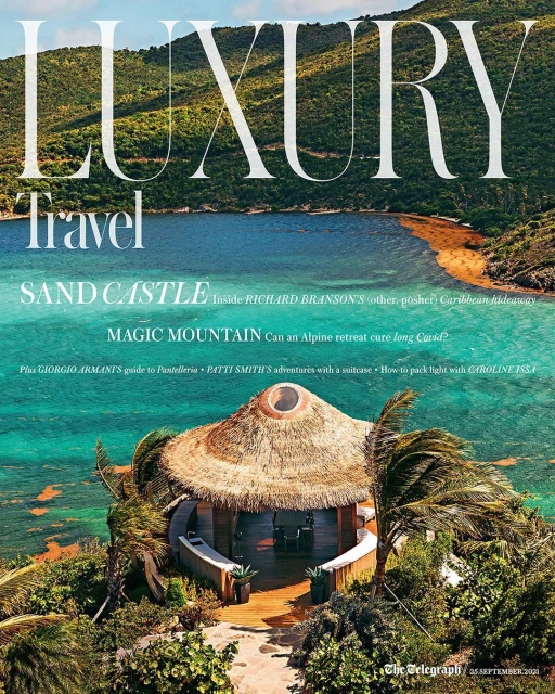 Magazine cover featuring tropical island resort, lagoon, and hills, overlaid with "Luxury Travel" title and article previews.